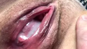 Spunk flows from a wide, swollen and boned up snatch. Close-up.