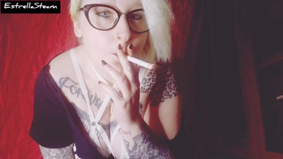 Blonde smokes a cigarette while staring at you