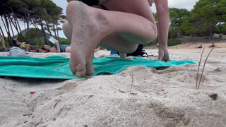 skank changes her panties on the public beach and flashes her vagina
