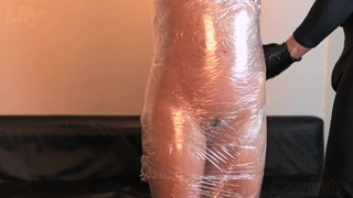 Innocent MILF signs up for BDSM session, gets wrapped up in plastic foil and drilled | Lily Corinth