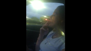 Milf smoking cigarettes while in passenger seat in vehicle